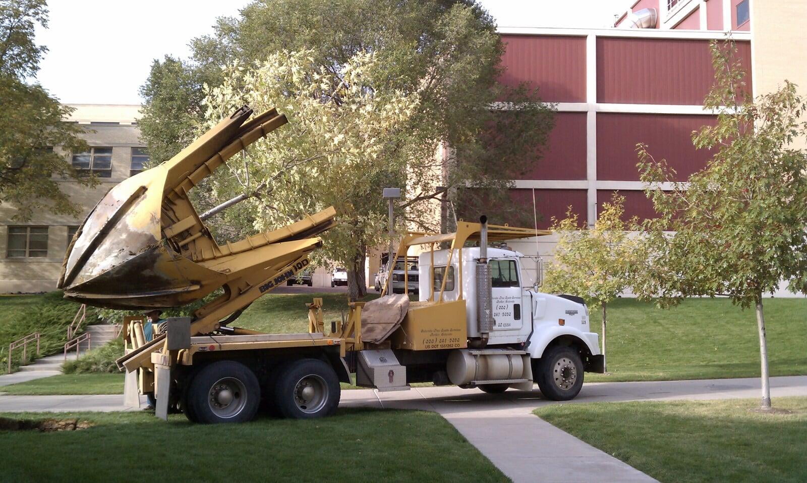 The Big John, a transplanting machine, being used to move a large tree